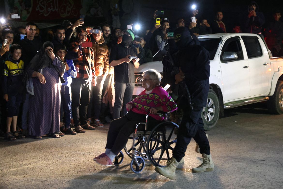 Hamas and Islamic Jihad fighters accompany a newly released hostage before the hand over to the Red Cross in Rafah