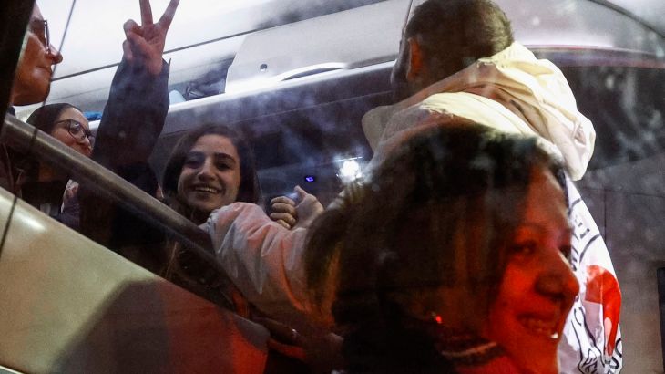 A newly released Palestinian detainee gestures from inside a Red Cross bus carrying Palestinian prisoners released from Israeli jails in exchange for hostages released by Hamas from the Gaza Strip, in Ramallah in the occupied West Bank on November 28
