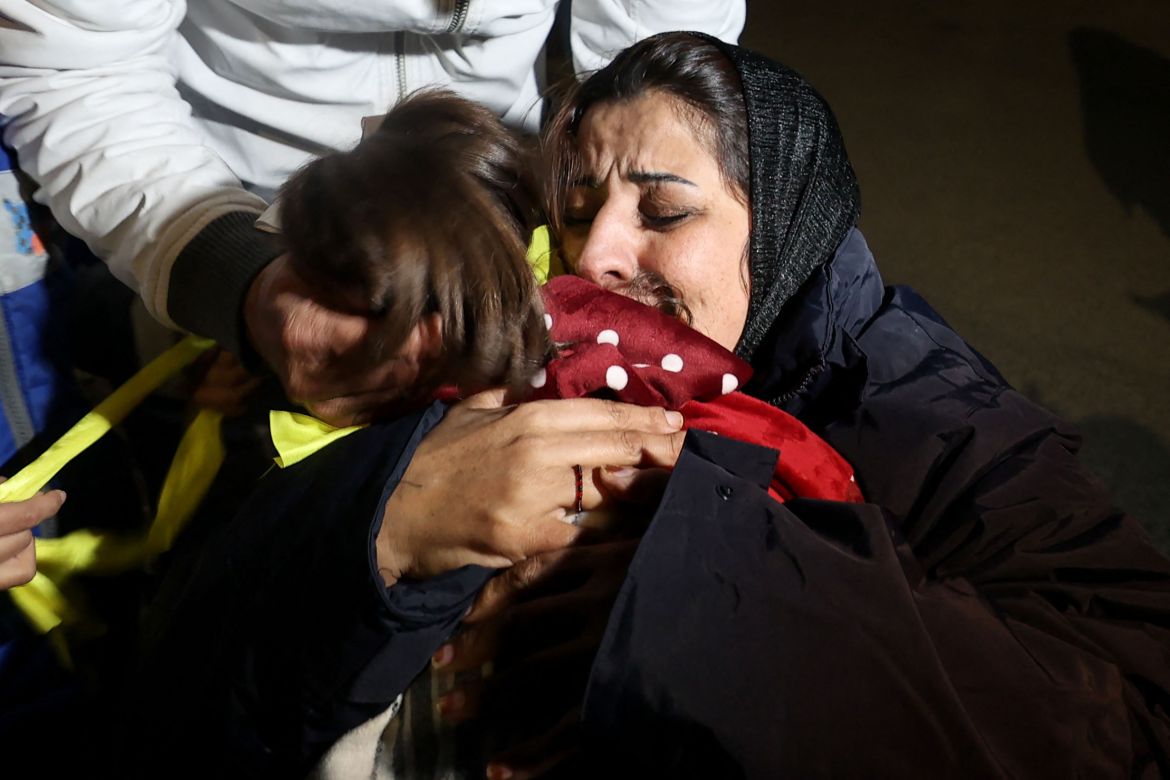 Newly released Palestinian prisoner Manal Dudeen hugs her daughter after disembarking a Red Cross bus transporting prisoners freed from Israeli jails.