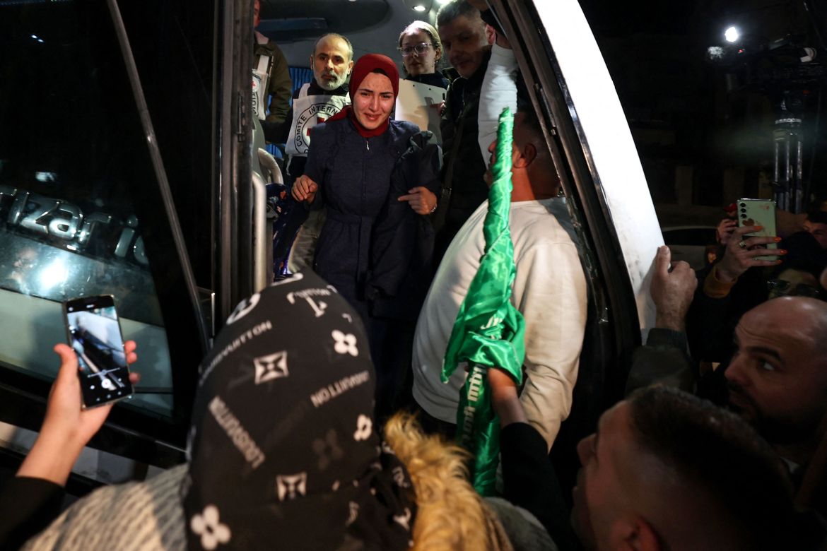 A newly released prisoner disembarks a bus during a welcome ceremony following the release of Palestinian prisoners from Israeli jails in exchange for Israeli hostages held in Gaza by Hamas.
