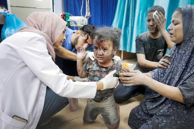 A doctor examines an injured child at the Al Aqsa Hospital after the Israeli attack on Maghazi Refugee Camp in Deir al Balah, Gaza
