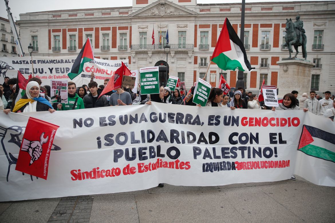 Students, holdings placards and flags, gather to stage protest in support of Palestinians in Madrid, Spain.