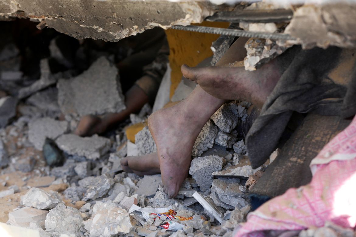 Lifeless bodies are being removed from the rubble of the building that collapsed following an Israeli attack on a house belonging to the al-Haj family at the Nuseirat refugee camp in Deir al-Balah, Gaza.