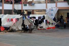 Hung clothes are seen as Palestinians, displaced from their homes as a result of the Israeli attacks, try to continue their daily lives at Aliva School in Rafah, Gaza on November 30, 2023. [Abed Rahim Khatib/Anadolu Agency]