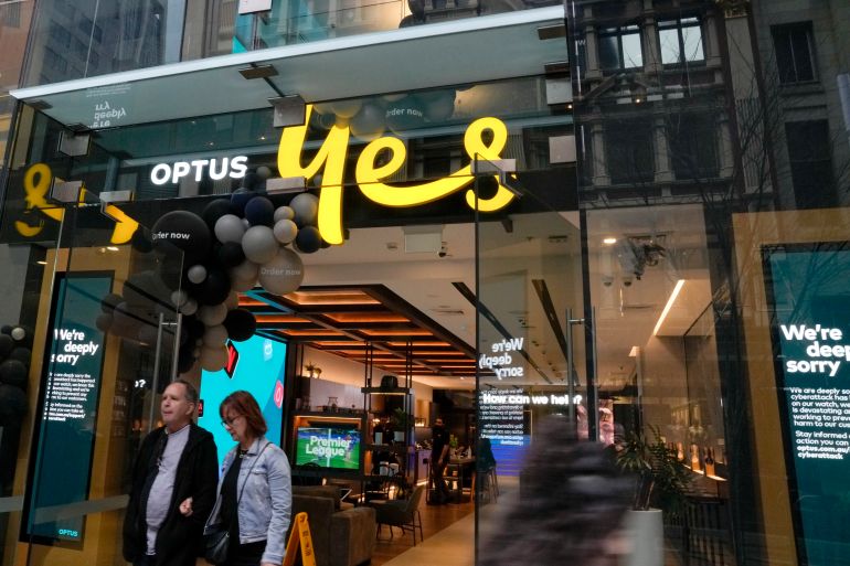 An Optus shop in Sydney, Two customers are walking out of the doors and onto the street