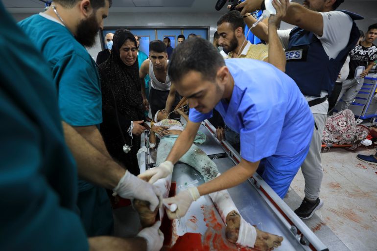 Palestinian medic treats wounded in the Israeli bombardment at Shifa Hospital in Gaza City, Monday, Oct. 23, 2023
