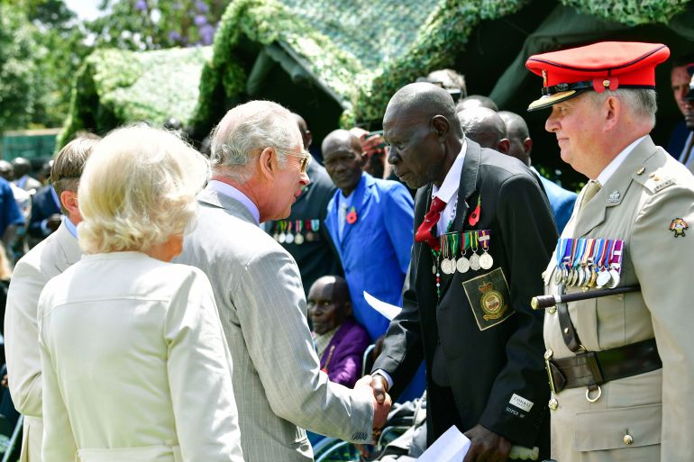 Britain's King Charles III and Queen Camilla, meet Kenyan war veteran Michael Deya, 2nd right, during a visit to Kariokor World War II Commonwealth Cemetery