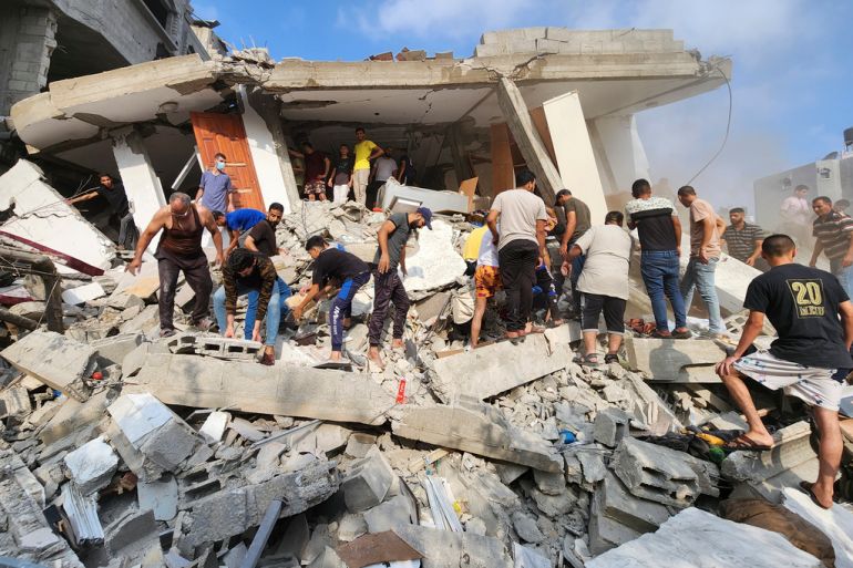Palestinians search for survivors of an Israeli strike in a destroyed building