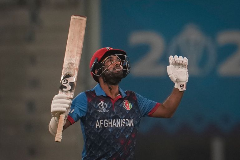 Afghanistan's captain Hashimatullah Shahidi celebrates his fifty runs by holding up his bat and looking to the sky