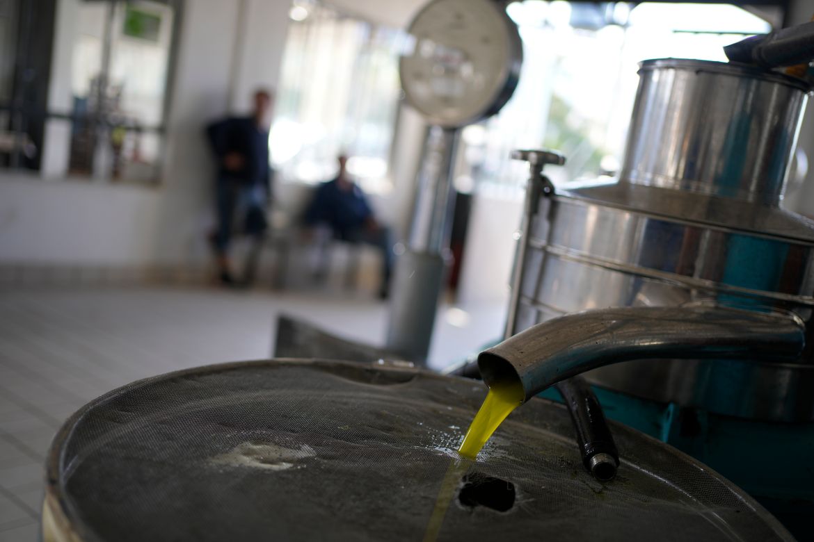 A tank is filled with olive at an olive mill in Spata suburb, east of Athens, Greece.