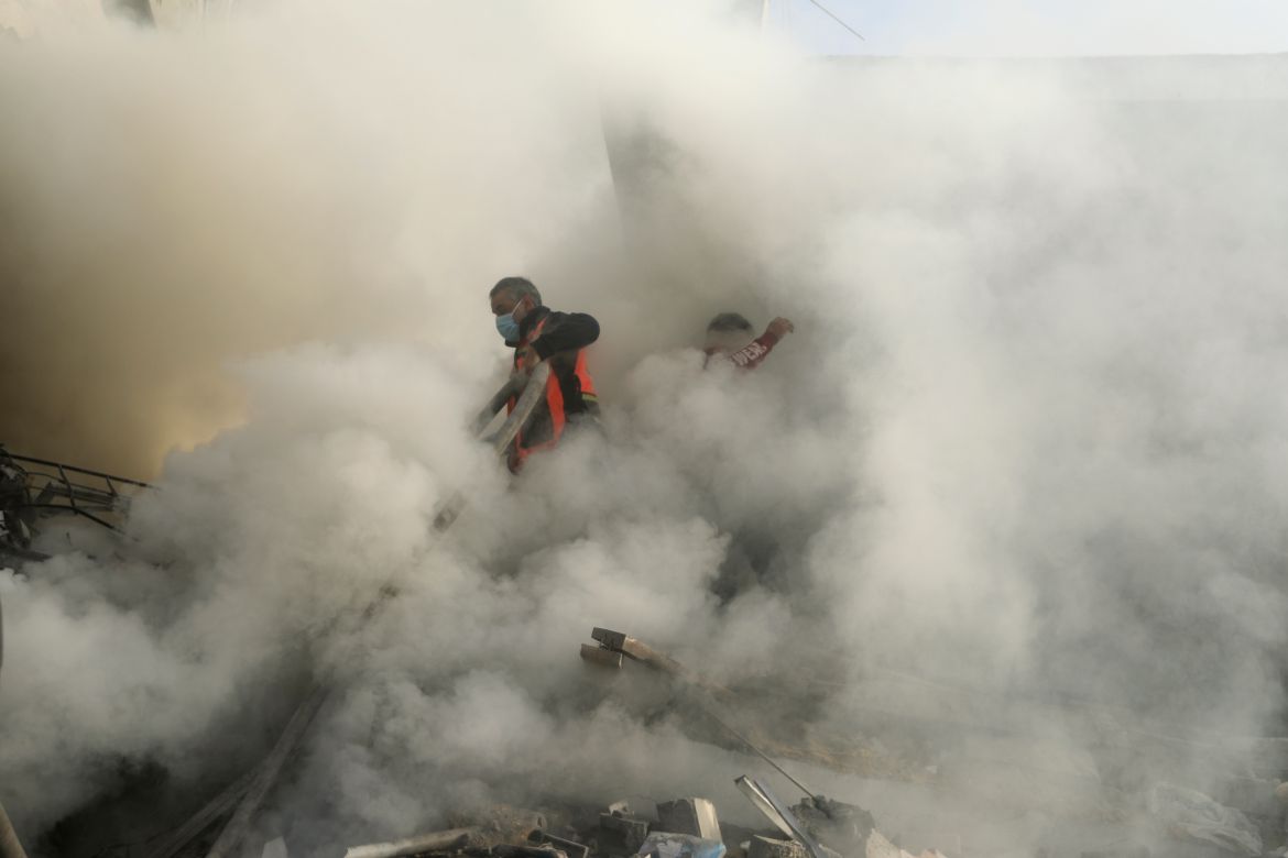 Palestinian firefighters extinguish fire caused by an Israeli airstrike in Khan Younis refugee camp, southern Gaza Strip.