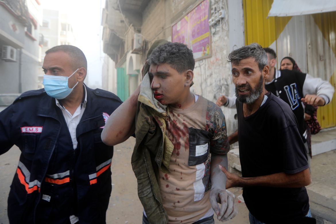 Palestinians evacuate a wounded youth following an Israeli airstrike in Khan Younis refugee camp, southern Gaza Strip.