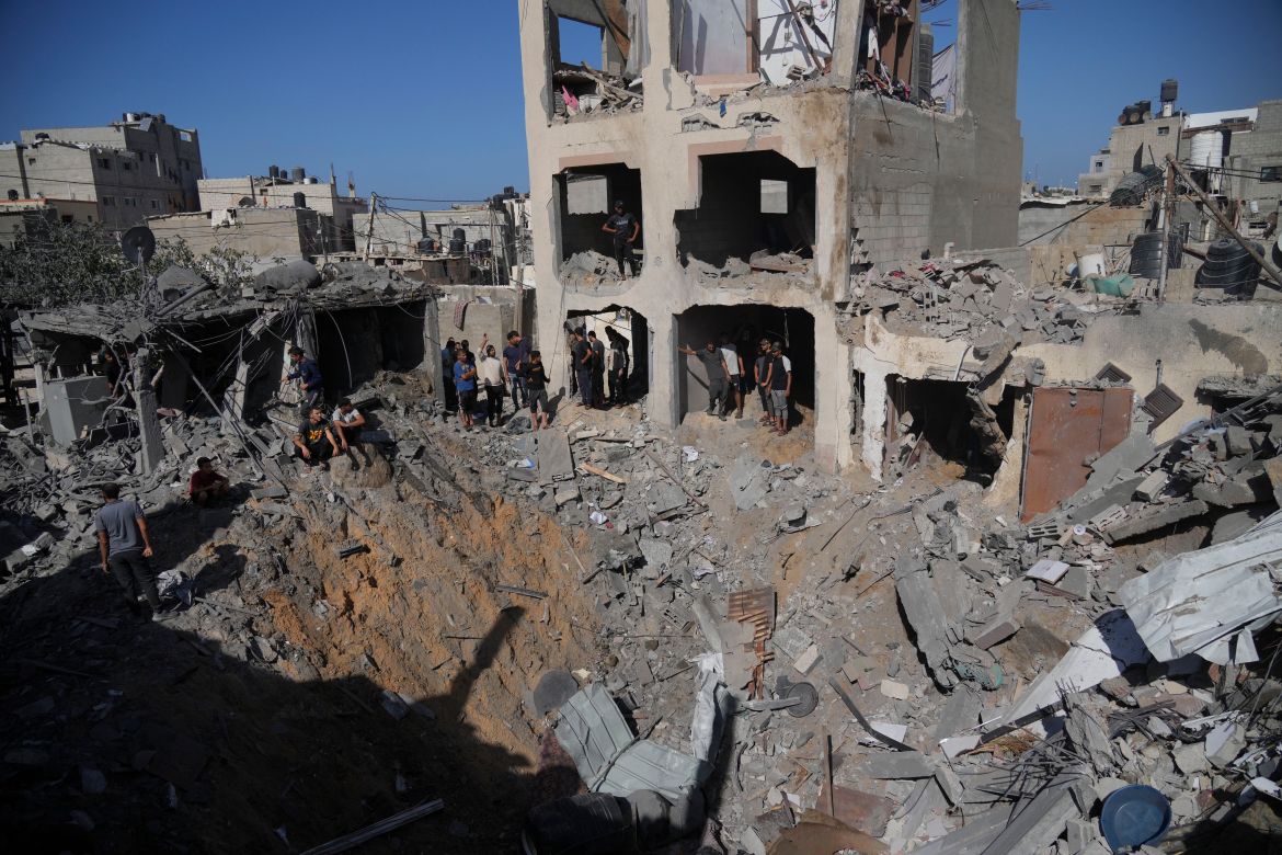 Palestinians look at buildings destroyed in the Israeli bombardment in the morgue in Deir al Balah, Gaza Strip.