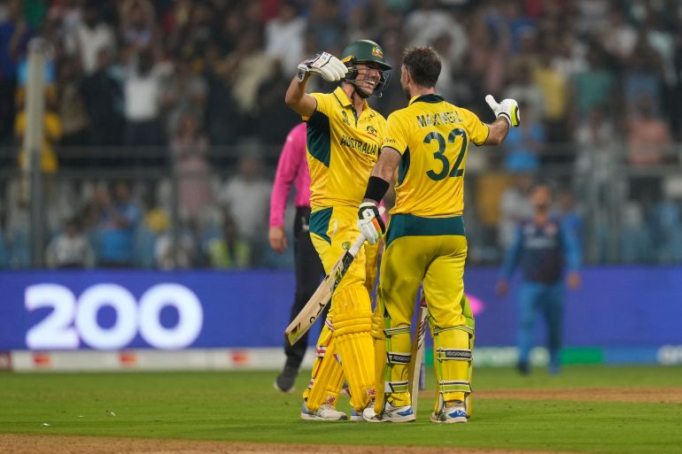 Australia's Glenn Maxwell, right, celebrates with captain Pat Cummins after their win in the ICC Men's Cricket World Cup match against Afghanistan in Mumbai, India, Tuesday, Nov. 7, 2023. (AP Photo/Rajanish Kakade)