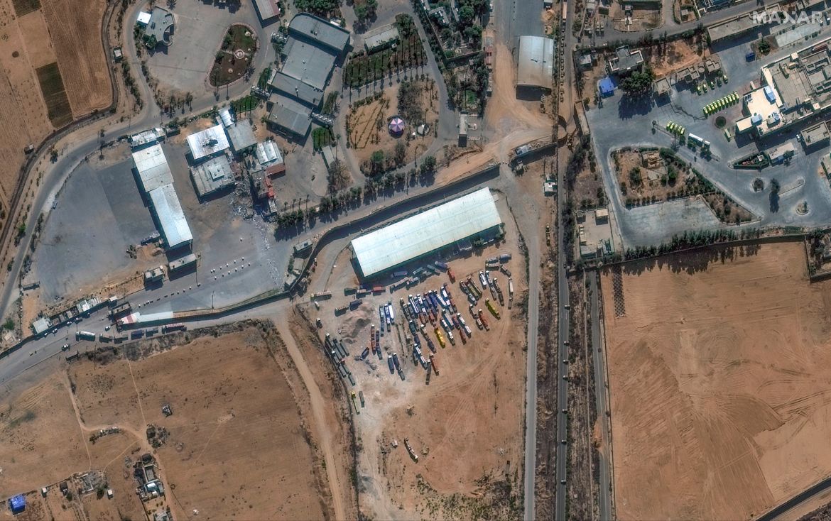 This image provided by Maxar Technologies shows a close view of the Rafah border crossing between Gaza and Egypt, with humanitarian-associated trucks lined up at and near the border.