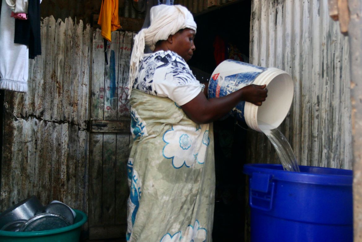 A woman empties her bucket of water in the district of M'tsamoudou, near Bandrele on the French Indian Ocean territory of Mayotte.