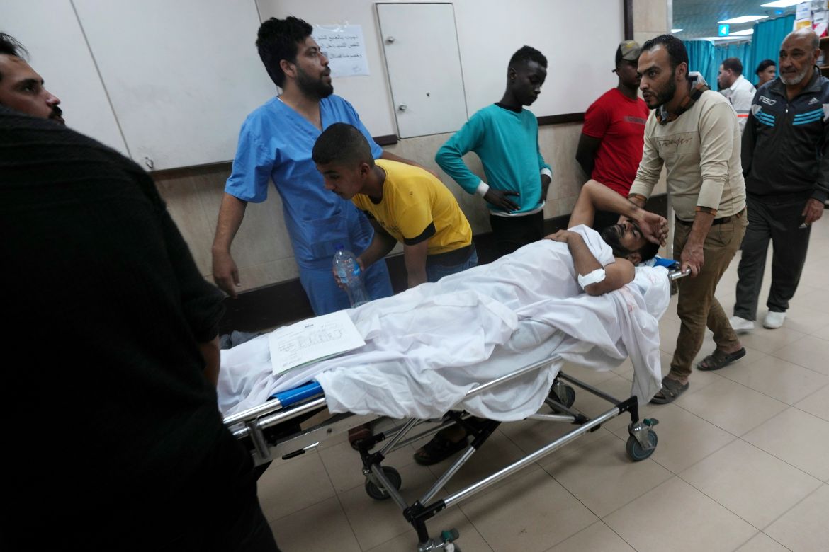 Palestinians wounded in the Israeli bombardment of the Gaza Strip are brought to a treatment room of al Aqsa Hospital on Deir al Balah