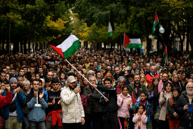 Demonstrators wave Palestinian flags as they protest during a demonstration against Israeli attacks on Gaza, in Pamplona, northern Spain.