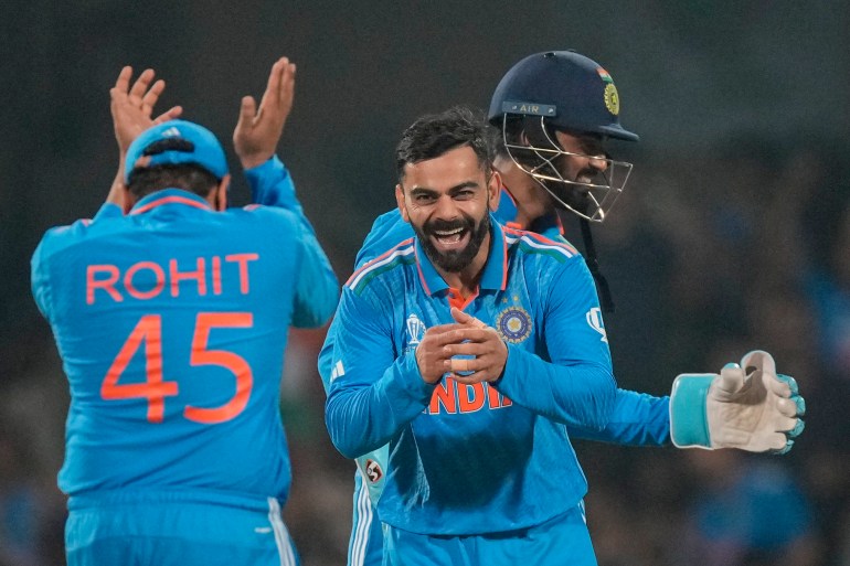 India's Virat Kohli, centre, celebrates the wicket of Netherlands' captain Scott Edwards during the ICC Men's Cricket World Cup match between India and Netherlands in Bengaluru, India, Sunday, Nov. 12, 2023. (AP Photo/Anupam Nath)