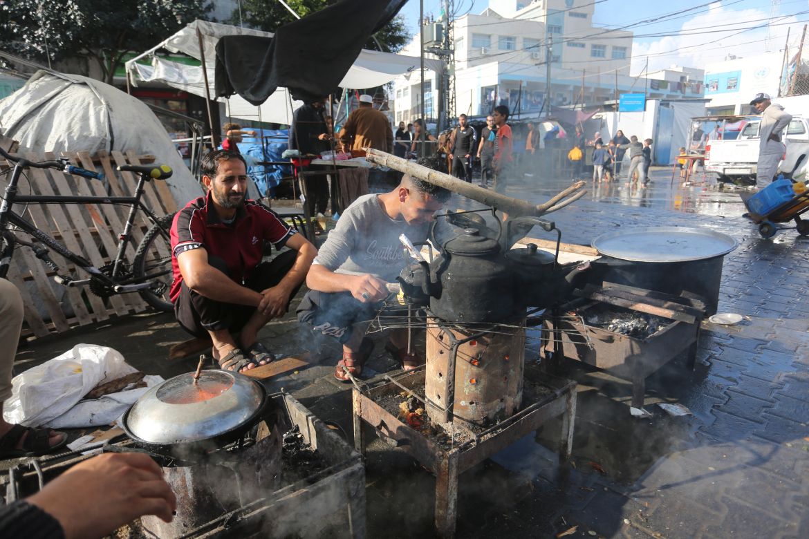 Palestinians cook at a square in Rafah, Gaza Strip, during the ongoing Israeli bombardment of the Gaza Strip.