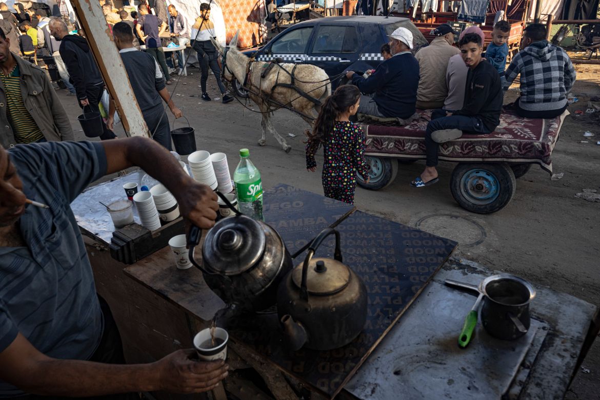 A Palestinian sells tea during the ongoing Israeli bombardment of the Gaza Strip in Khan Younis on Friday