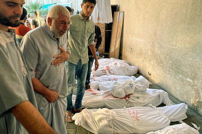 A Palestinian man reacts over the body of a relative as bodies of those killed by Israeli airstrikes on Jabaliya refugee camp are lined up, at the Indonesian hospital, northern Gaza Strip.