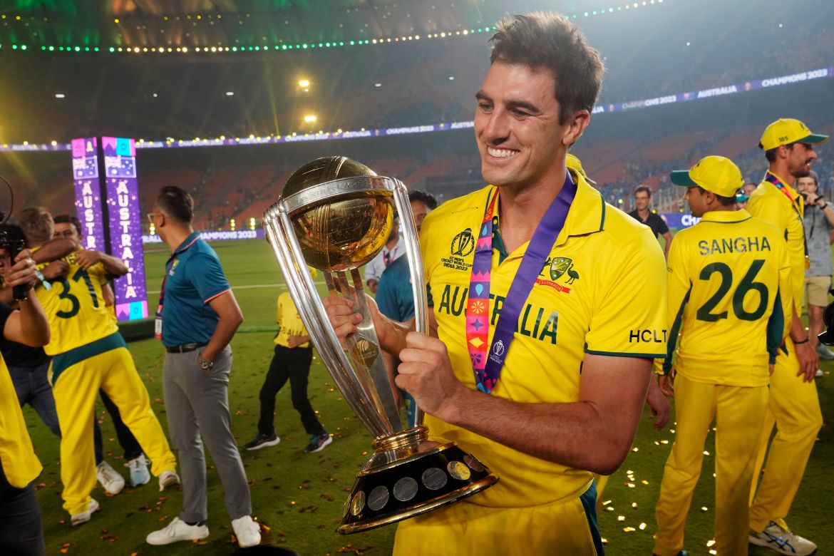 Australia's captain Pat Cummins poses for a photograph with the trophy after Australia won the ICC Men's Cricket World Cup final match against India in Ahmedabad, India.