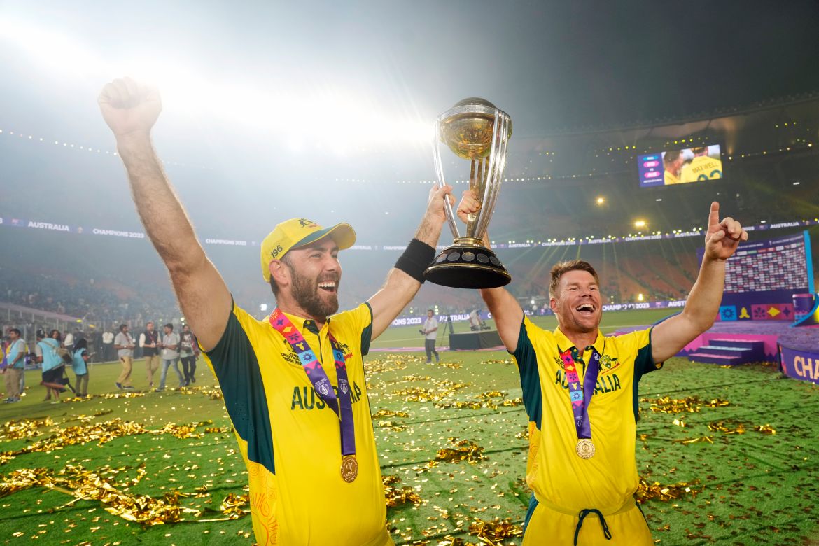Australia's Glenn Maxwell, left, holds the trophy with teammate David Warner after Australia won the ICC Men's Cricket World Cup final match against India in Ahmedabad, India.