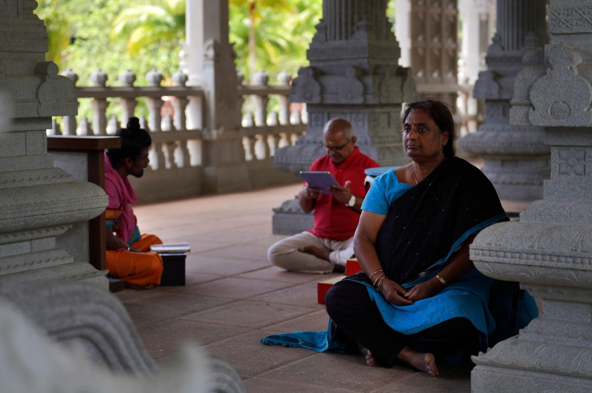 Devajyothi Kondapi, right, a pilgrim who visits from Portland, Oregon a few times a year, meditates in the Iraivan Temple as her husband practices a chant, at Kauai's Hindu Monastery.