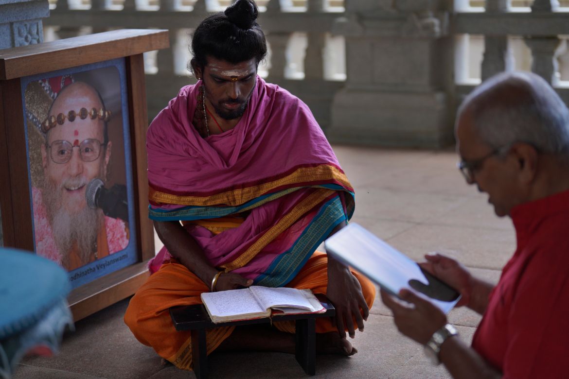 Pravinkumar Vasudeva, left, who serves as priest of Iraivan Temple, teaches a pilgrim from Portland, Oregon, at the Kauai Hindu Monastery.