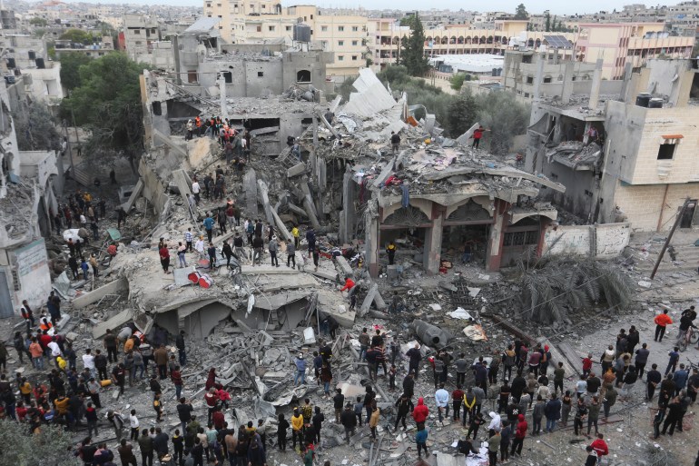 Palestinians search for survivors of the Israeli bombing in Rafah, Gaza Strip