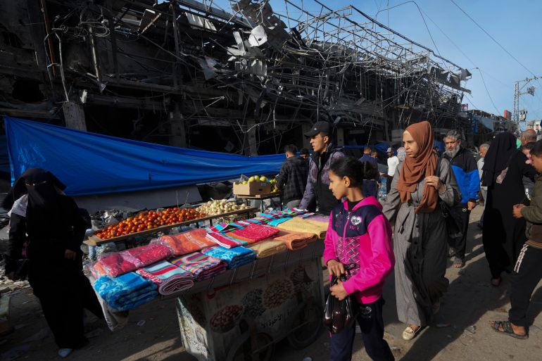 Palestinians buy vegetables and necessities in Nusseirat refugee camp, central Gaza Strip, on Saturday, Nov. 25