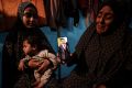 Zeenat al-Samouni shows a photo of her son Abdullah, 24, who was taken by Israeli soldiers at a checkpoint on the so-called 'safe corridor' in Gaza