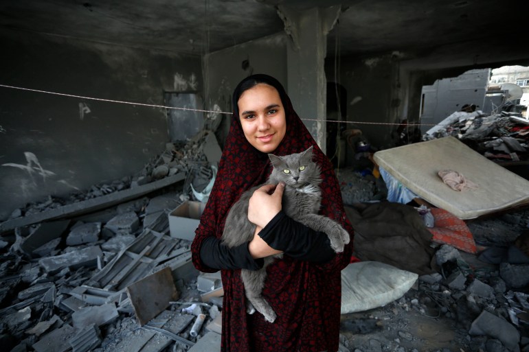 Layan Naji and her cat Sondos in their home in Deir al-Balah 