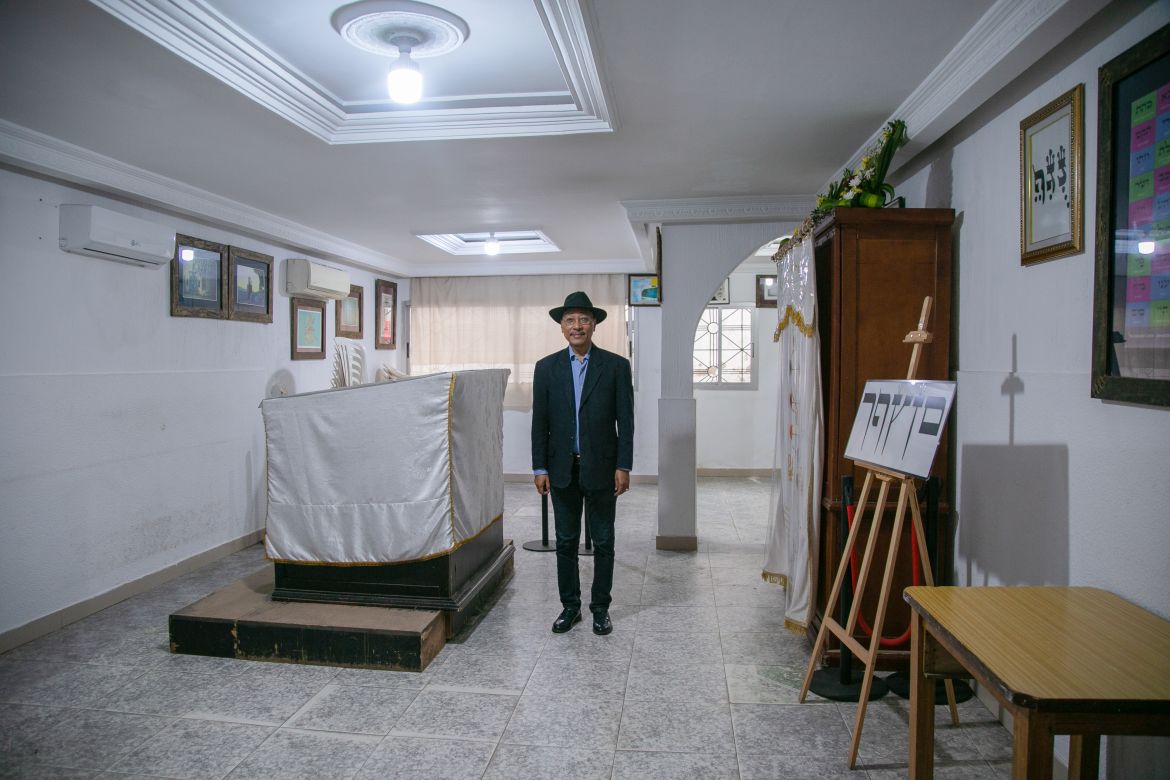 Firmin Yehuda stands inside the synagogue he built