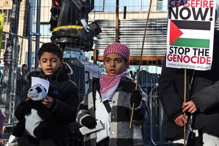 Children sing and recite poems as pro-Palestinian demonstrators rally on Waverley Bridge, before marching along Princes Street, in Edinburgh, Scotland.