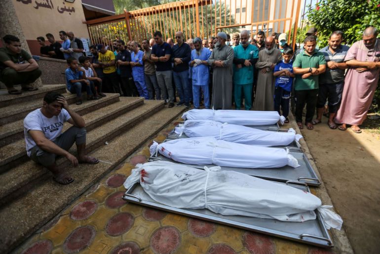 People mourn as they collect the bodies of Palestinians killed in Israeli air raids on November 5, 2023 in Khan Yunis, Gaza.