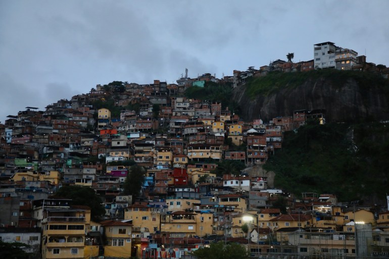A hillside packed with houses, under a grey sky.