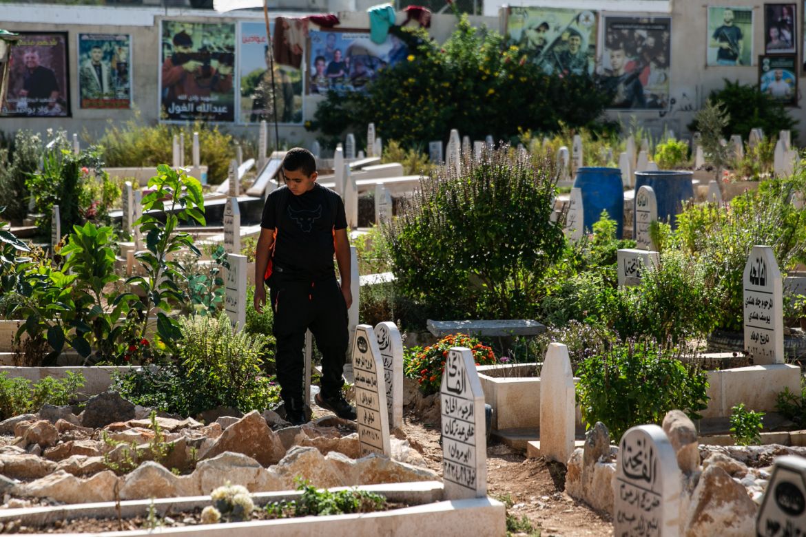 A child visits the graves of fighters killed in clashes with Israeli forces in the cemetery of the Jenin refugee camp