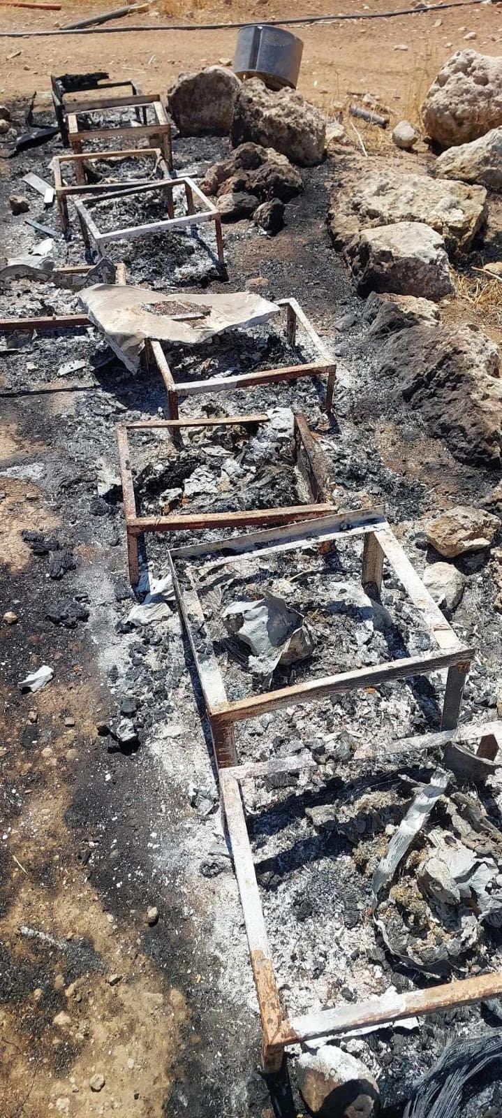 The burned bee hives on the farm of Salah Awwad