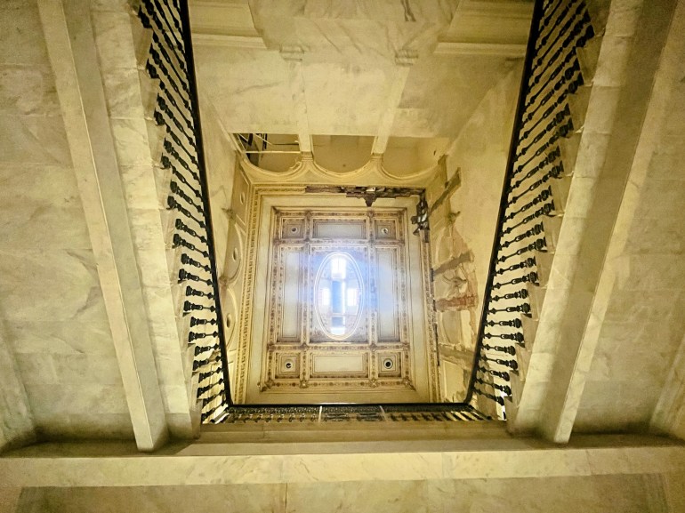 A view looking up from the base of the stairs at the damaged cupola