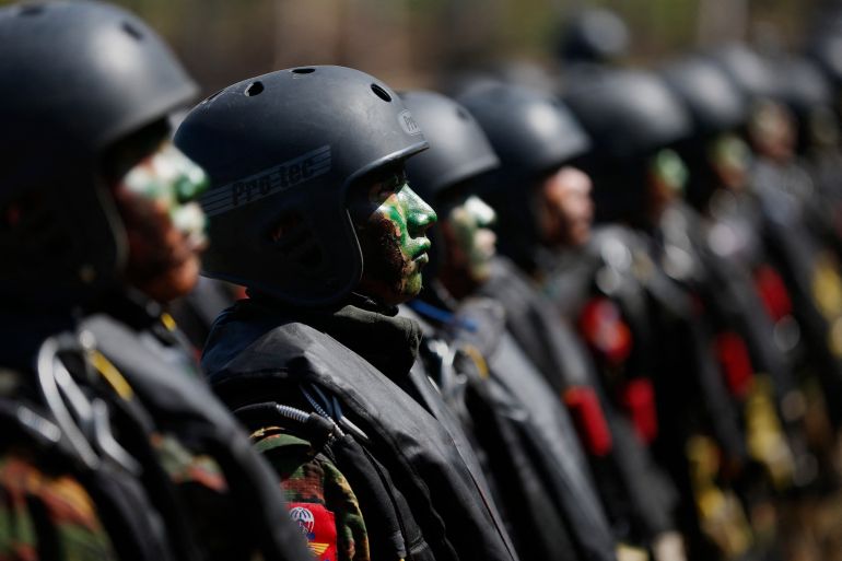Myanmar soldiers taking part in a drill in 2018. They are standing to attention and have camouflage paint on their faces