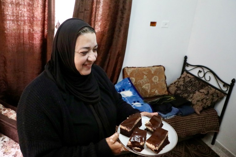 Fidaa with a plate of iced chocolate cakes