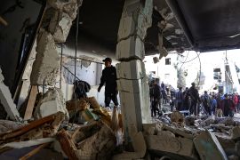Palestinians check the damage in a house following an Israeli raid in the occupied West Bank city of Jenin on November 29, 2023 [Zain Jaafar/AFP]