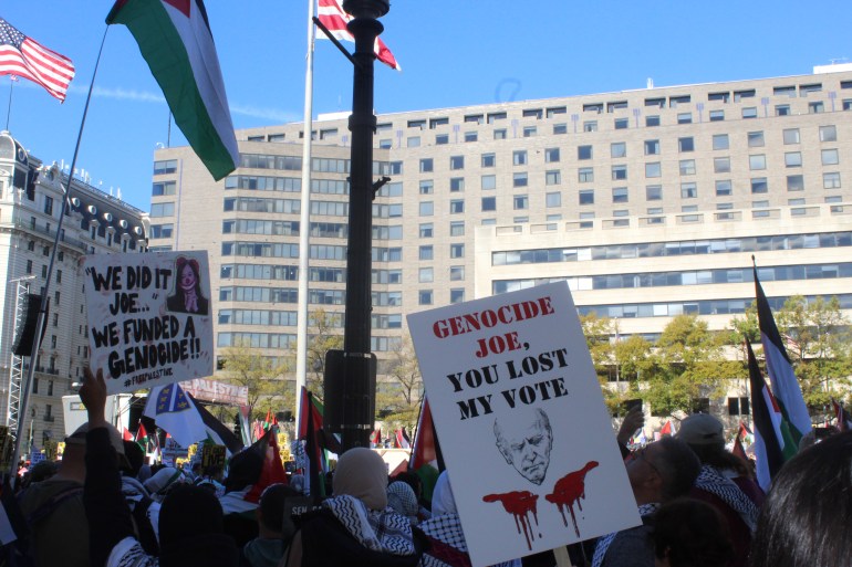 Protester in Washington, DC holding a sign that reads: 'Genocide Joe, you lost my vote'