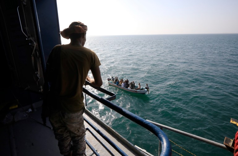 A boat carries people as a Houthi fighter keeps watch on the deck of the Galaxy Leader cargo ship, seized by the Houthis offshore of the Al-Salif port on the Red Sea in the province of Hodeidah, Yemen, 05 December 2023 (issued 06 December 2023). Yemen's Houthis on 06 December 2023 claimed responsibility for the launch of the barrage of ballistic missiles toward Israel in support of the Palestinian people in the Gaza Strip, according to a statement by Houthis spokesman Yahya Saree. The Houthis vowed to continue their efforts to prevent Israeli ships from navigating in the Arabian and Red Seas, in retaliation for Israel's airstrikes on the Gaza Strip. Thousands of Israelis and Palestinians have died since the militant group Hamas launched an unprecedented attack on Israel from the Gaza Strip on 07 October, and the Israeli strikes on the Palestinian enclave which followed it. EPA-EFE/YAHYA ARHAB