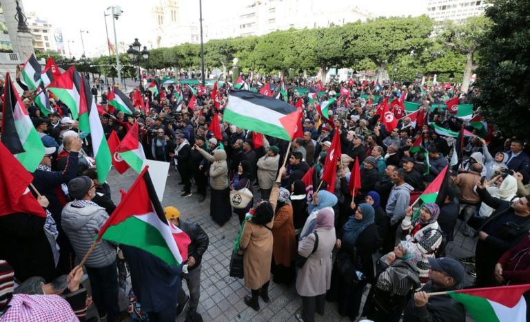 Tunisian protesters carry Palestinian flags as they take part in a rally, organized by the Tunisian National Salvation Front opposition coalition, in solidarity with the Palestinian people and demanding the release of Tunisian political detainees, in Tunis, Tunisia.