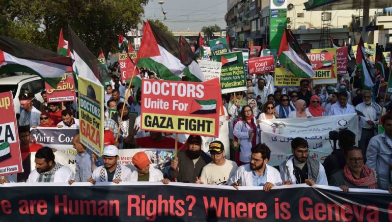 Pakistani doctors and medics hold Palestinian flags during a demonstration in solidarity with the Palestinian people, in Karachi, Pakistan.