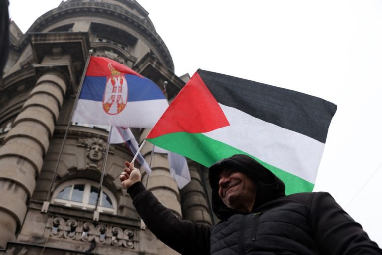 A man waves a Palestinian flag in front of the Government headquarters during a rally of support for Palestinian people in Belgrade, Serbia.
