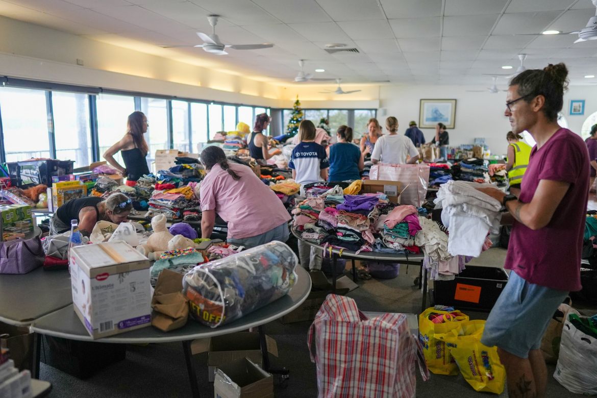 Volunteers process donations brought in by residents to assist flood victims at the Cairns Cruising Yacht Squadron evacuation centre in Cairns, Queensland, Australia, 18 December